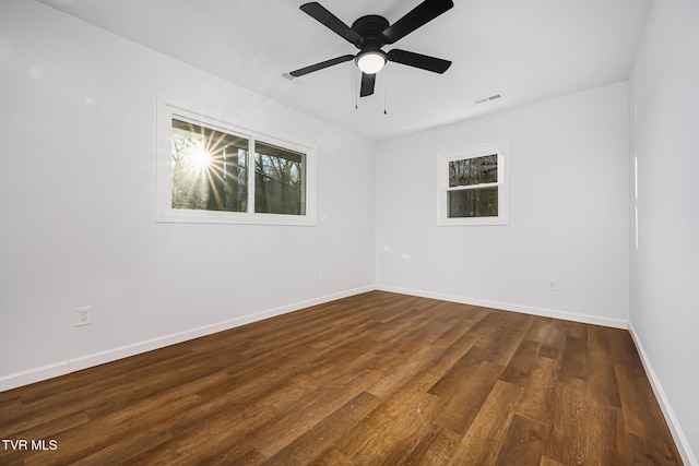 empty room featuring ceiling fan and dark wood-type flooring