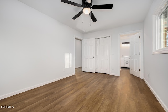 unfurnished bedroom with ceiling fan, a closet, and hardwood / wood-style floors