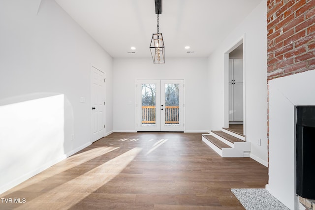 unfurnished dining area with french doors and hardwood / wood-style flooring