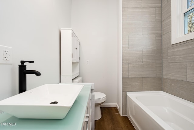 bathroom featuring hardwood / wood-style flooring, toilet, and vanity