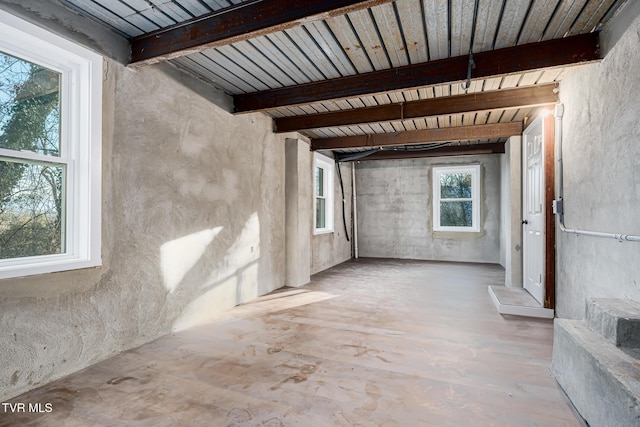 interior space featuring a wealth of natural light and beamed ceiling