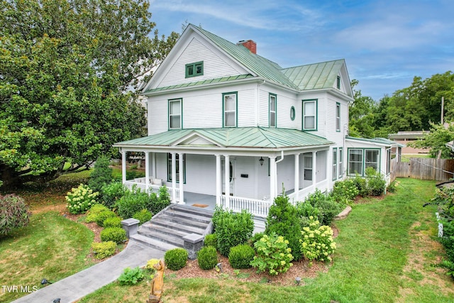 view of front of house with a porch and a front lawn