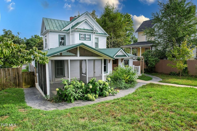 back of house featuring a lawn