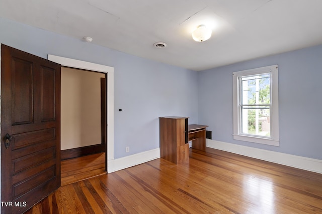 unfurnished room featuring wood-type flooring