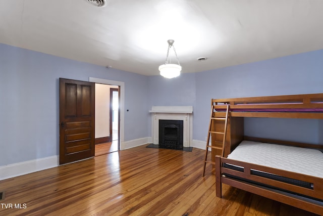 bedroom with wood-type flooring