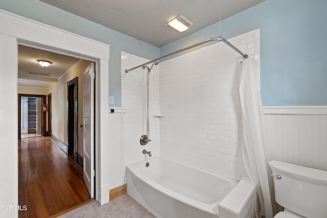 bathroom with toilet, tile patterned floors, and shower / bath combo