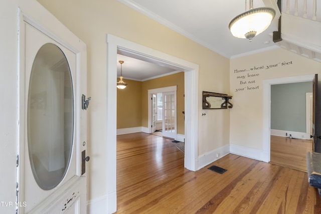 interior space with wood-type flooring and ornamental molding