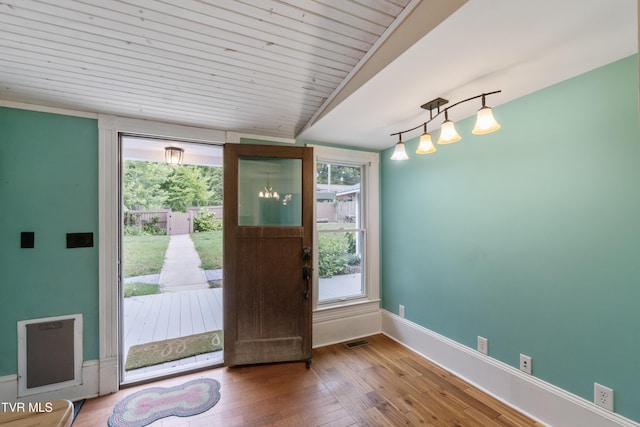 doorway featuring wood ceiling, hardwood / wood-style floors, and vaulted ceiling