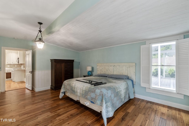 bedroom with dark wood-type flooring and lofted ceiling