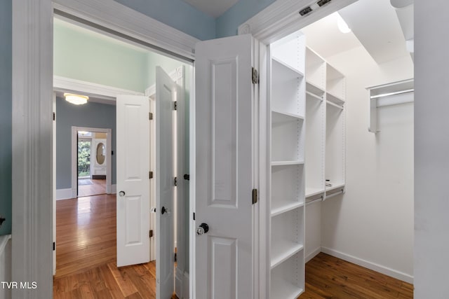 spacious closet featuring hardwood / wood-style floors