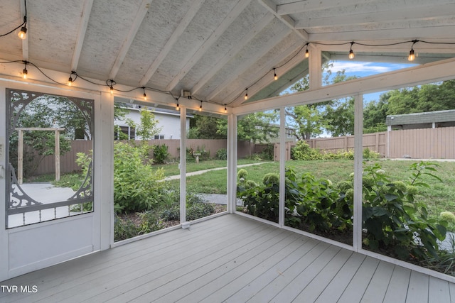 unfurnished sunroom with lofted ceiling