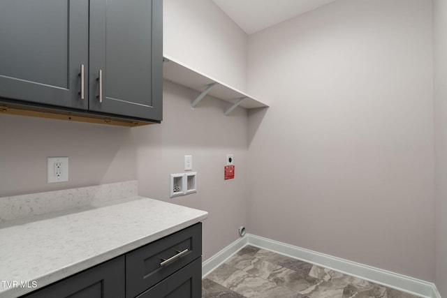 clothes washing area featuring cabinet space, hookup for a washing machine, hookup for an electric dryer, and baseboards