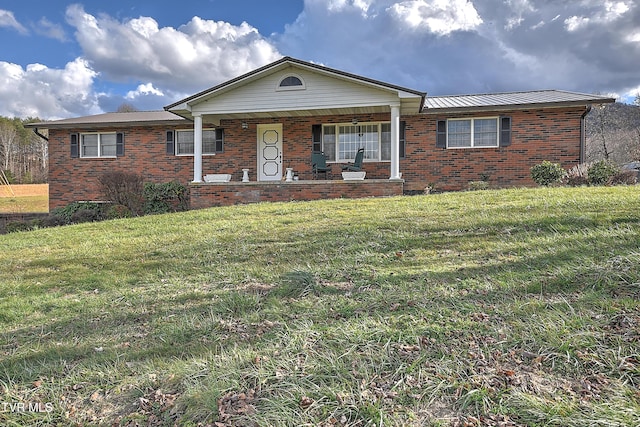 ranch-style home featuring a front yard and covered porch