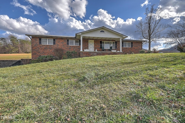 view of front facade with covered porch and a front lawn