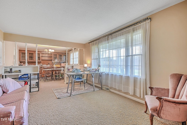 carpeted home office featuring a textured ceiling and a notable chandelier