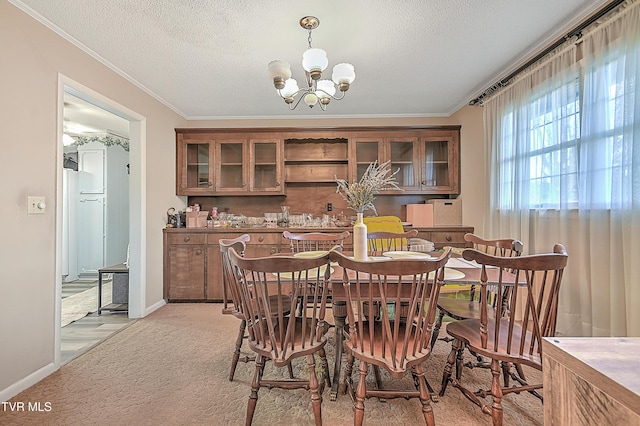 carpeted dining space with crown molding, a chandelier, and a textured ceiling