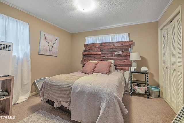 bedroom featuring a textured ceiling, crown molding, a closet, and light carpet