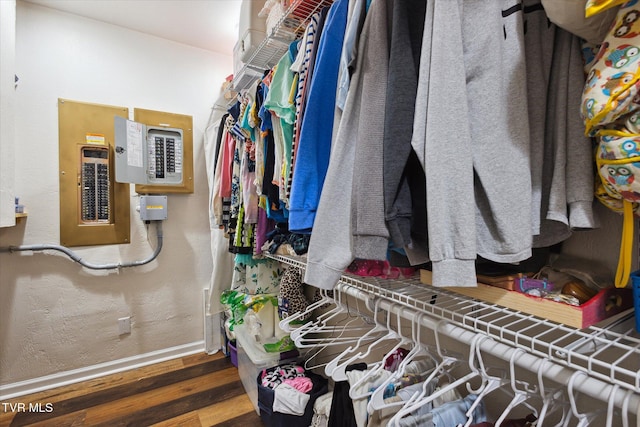 spacious closet featuring dark hardwood / wood-style floors