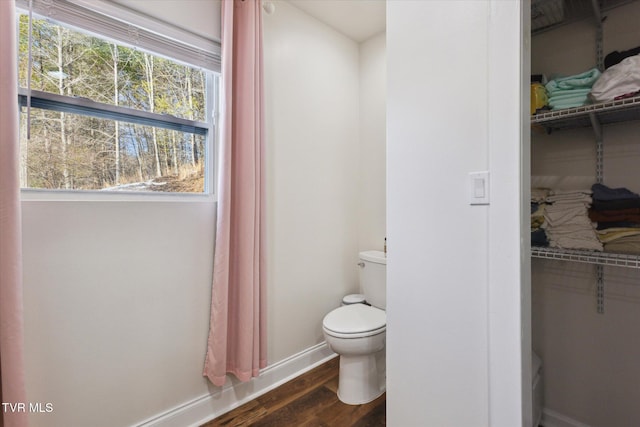 bathroom with wood-type flooring and toilet