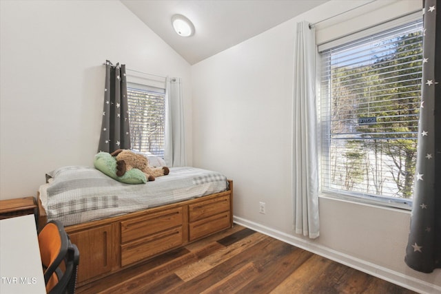 bedroom with lofted ceiling and dark hardwood / wood-style flooring