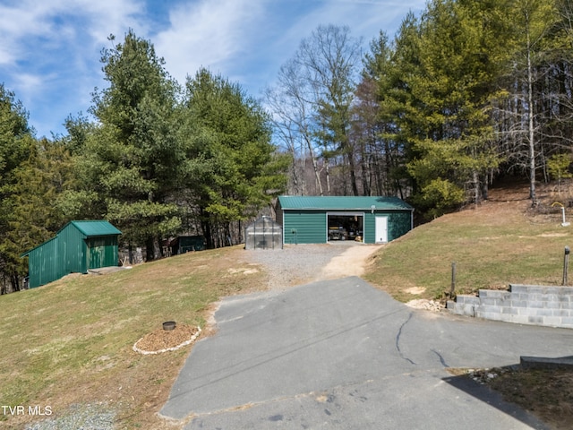 2191 Hubert Taylor Rd, Mountain City, TN 37683 - exterior space with a garage, an outdoor structure, a pole building, and aphalt driveway