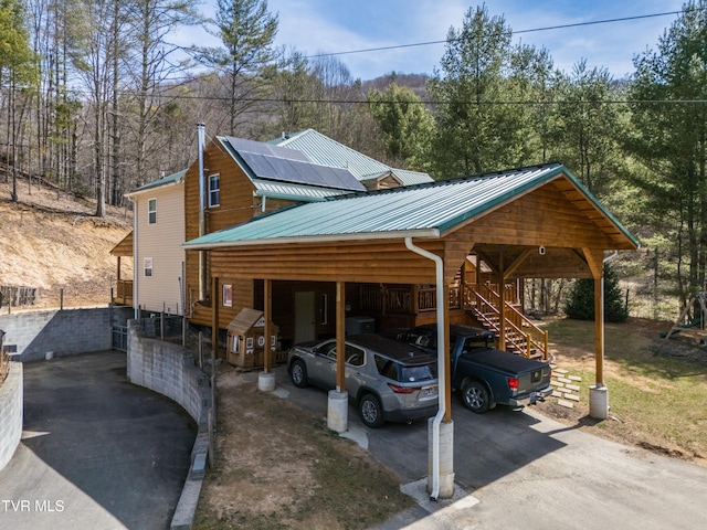 2191 Hubert Taylor Rd, Mountain City, TN 37683 - view of front of home featuring metal roof, roof mounted solar panels, a carport, and aphalt driveway