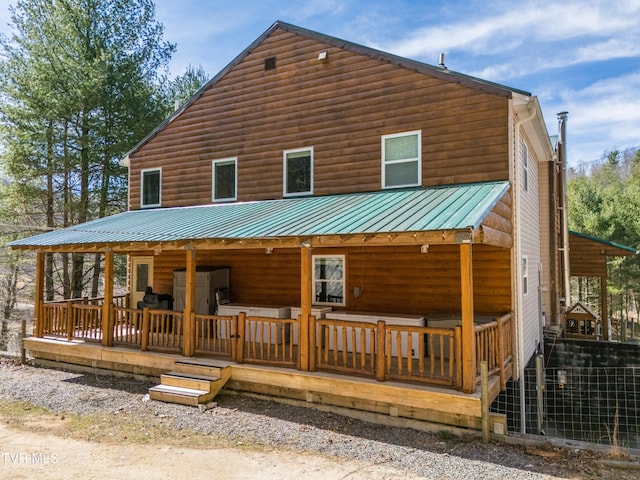 2191 Hubert Taylor Rd, Mountain City, TN 37683 - view of front of house with log veneer siding, covered porch, and metal roof