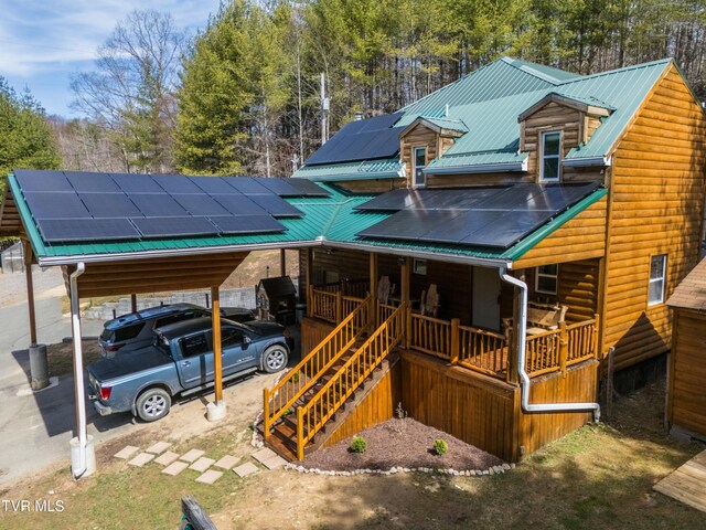 2191 Hubert Taylor Rd, Mountain City, TN 37683 - view of front of property with log veneer siding, stairway, solar panels, a porch, and metal roof