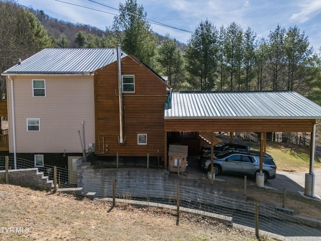 2191 Hubert Taylor Rd, Mountain City, TN 37683 - view of home's exterior with a carport, fence, driveway, and metal roof