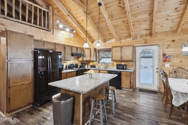 kitchen with decorative light fixtures, black appliances, wood ceiling, a kitchen island, and beamed ceiling