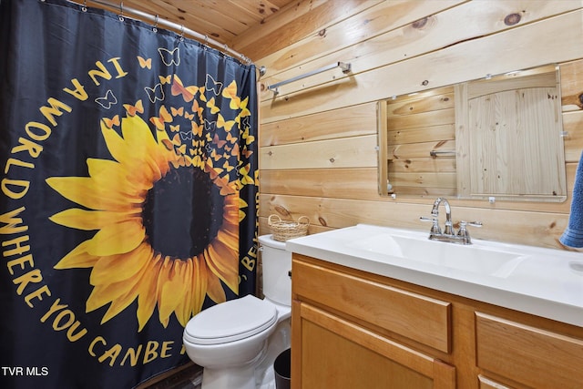 bathroom featuring wooden ceiling, wooden walls, vanity, and toilet