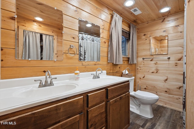 bathroom with wooden walls, wooden ceiling, hardwood / wood-style flooring, toilet, and vanity