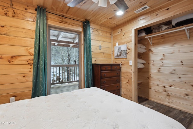 bedroom with wooden ceiling, wooden walls, access to outside, ceiling fan, and hardwood / wood-style flooring