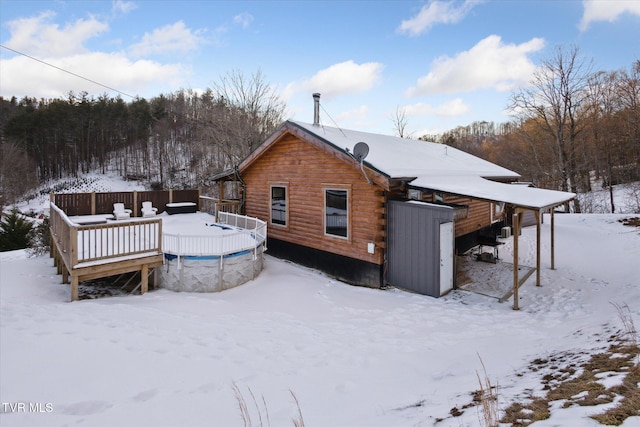 snow covered property featuring a wooden deck