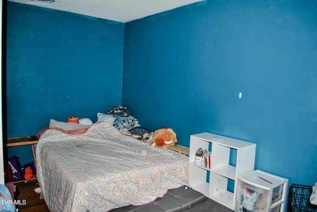 bedroom with hardwood / wood-style flooring