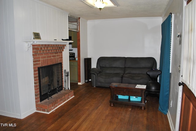 living room with a fireplace, a textured ceiling, crown molding, and dark hardwood / wood-style floors