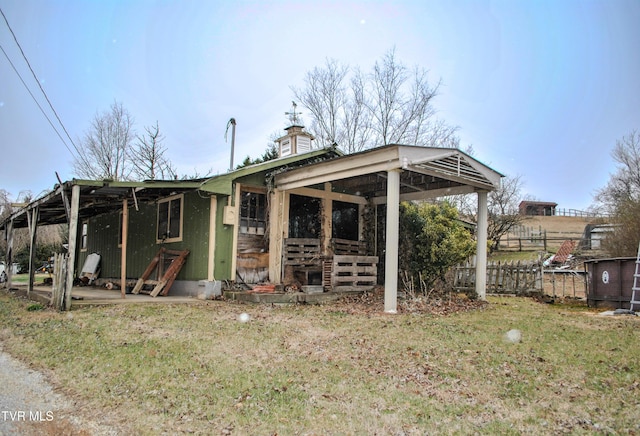 rear view of property with a yard