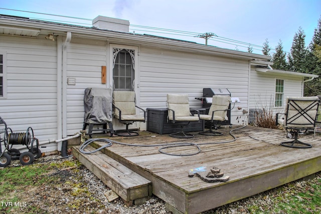 wooden deck featuring area for grilling