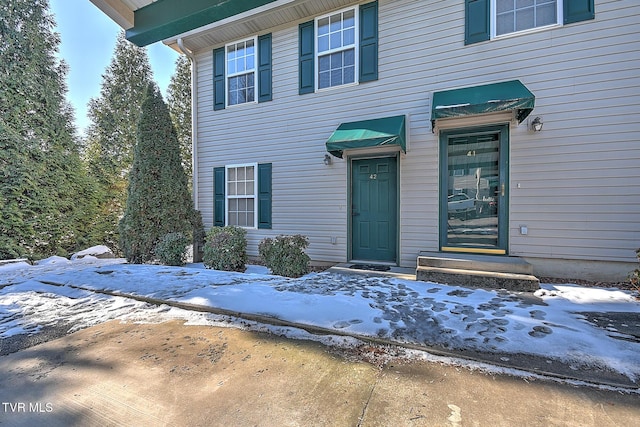 view of snow covered property entrance