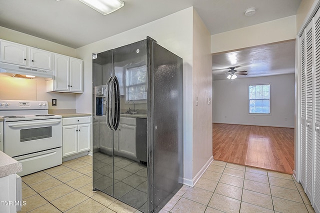 kitchen featuring electric range, ceiling fan, white cabinets, and light tile patterned floors