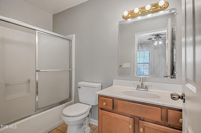 full bathroom with toilet, tile patterned floors, vanity, ceiling fan, and shower / bath combination with glass door