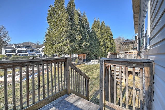 wooden deck featuring a yard