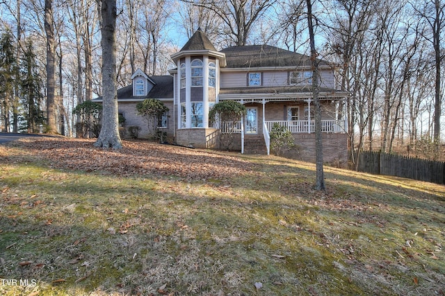 view of front of property with covered porch and a front lawn