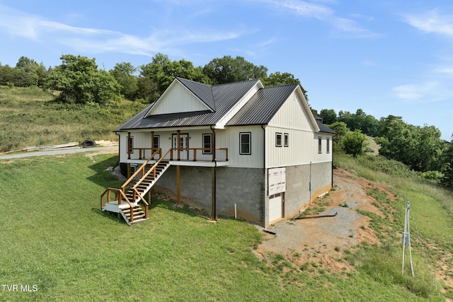 376 Wilcox Cir, Jonesborough, TN 37659 - view of front of house with a front yard, stairway, a porch, metal roof, and driveway