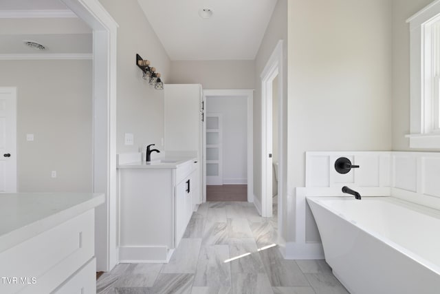 376 Wilcox Cir, Jonesborough, TN 37659 - bathroom featuring vanity, marble finish floors, a freestanding tub, baseboards, and ornamental molding