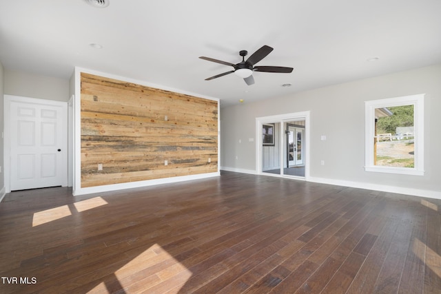 376 Wilcox Cir, Jonesborough, TN 37659 - unfurnished living room featuring wood finished floors, ceiling fan, baseboards, and wooden walls