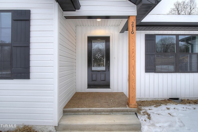 view of snow covered property entrance