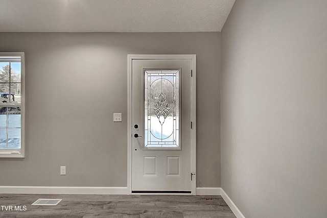 entrance foyer featuring a textured ceiling and hardwood / wood-style floors