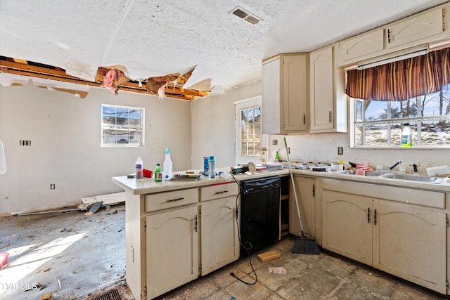 kitchen featuring sink, cream cabinets, dishwasher, and kitchen peninsula