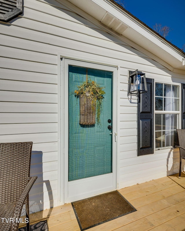 entrance to property with a wooden deck